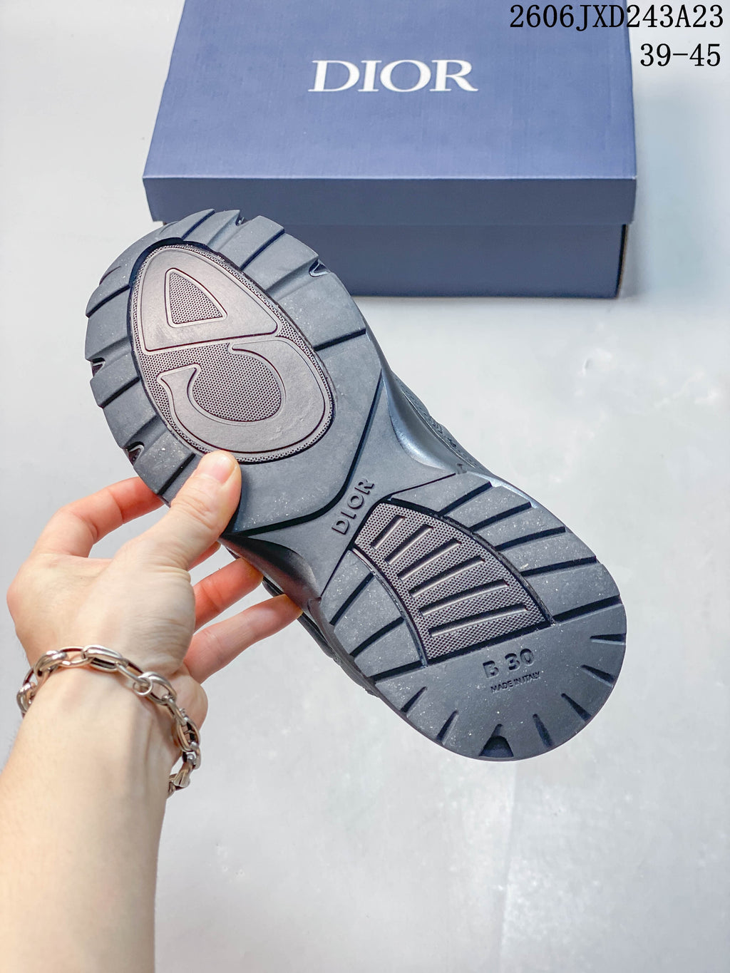Underside of a Dior B30 sneaker showing its tread and B30 marking