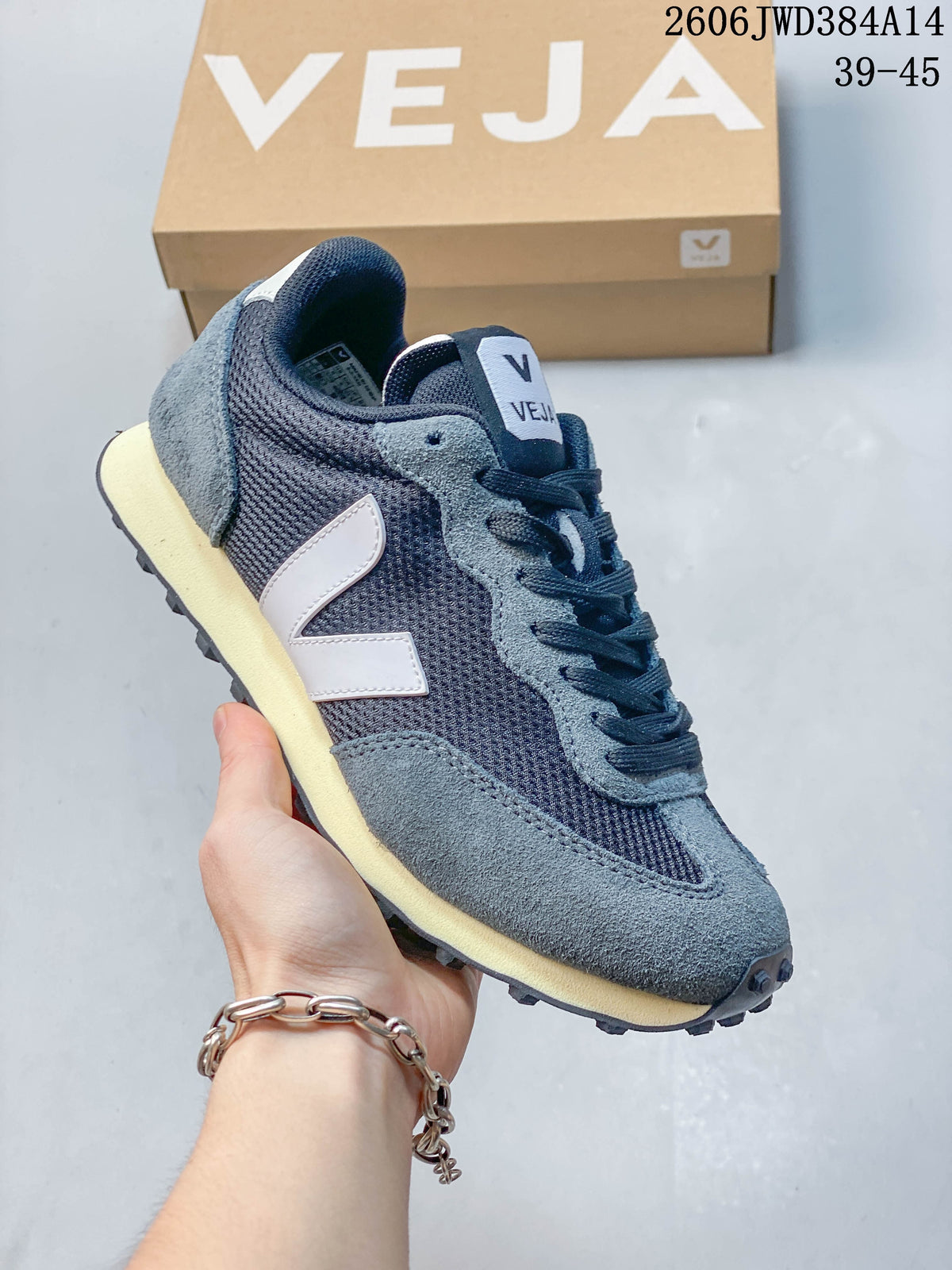 Dark navy and gray Veja sneaker with a white V-shaped side logo and cream-colored midsole.