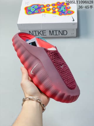 Side view of the red Nike Mind 001 mule showing its textured sidewall and small swoosh.