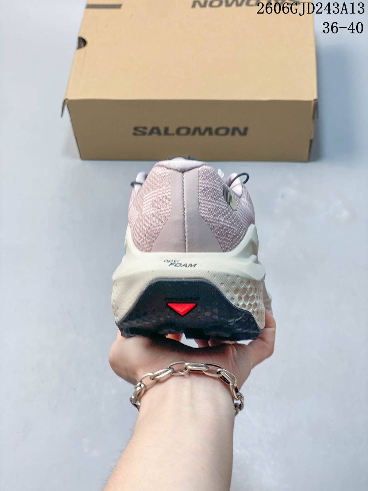 Rear view showing the heel and midsole of the pink trail running shoe.