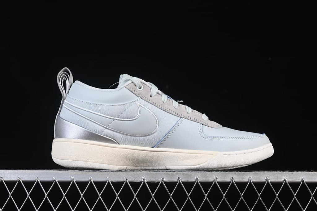 Side profile showing the gray upper and layered heel details