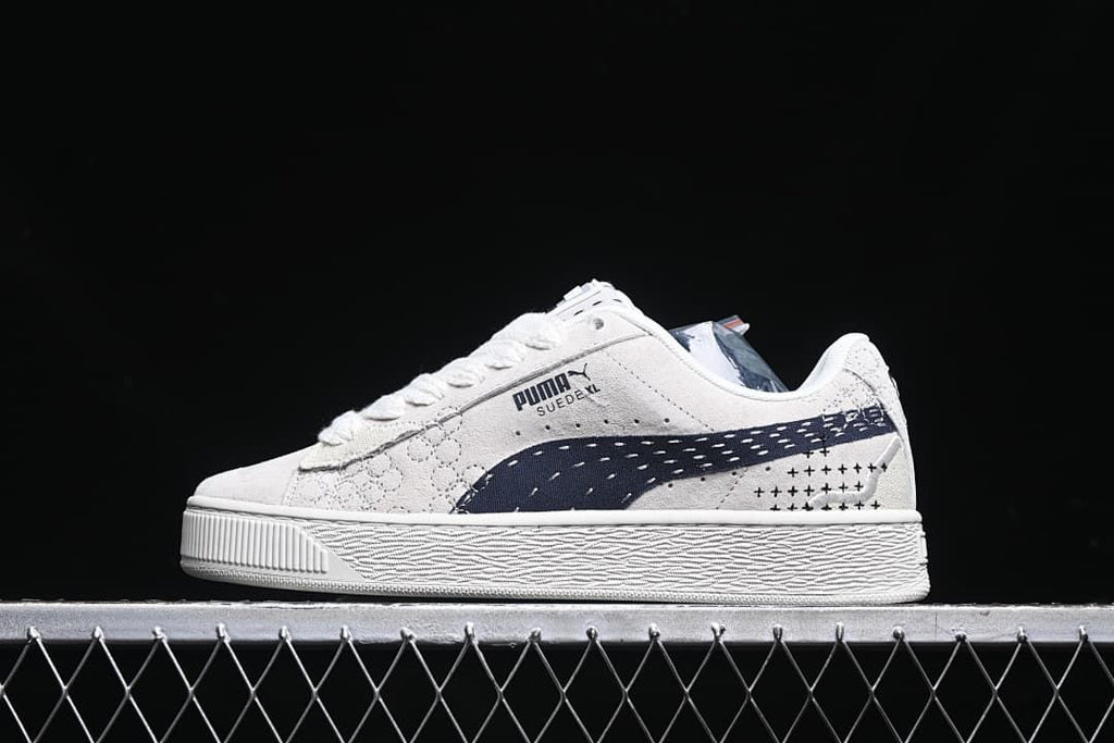 Side profile of the light-colored Puma Suede XL sneaker.