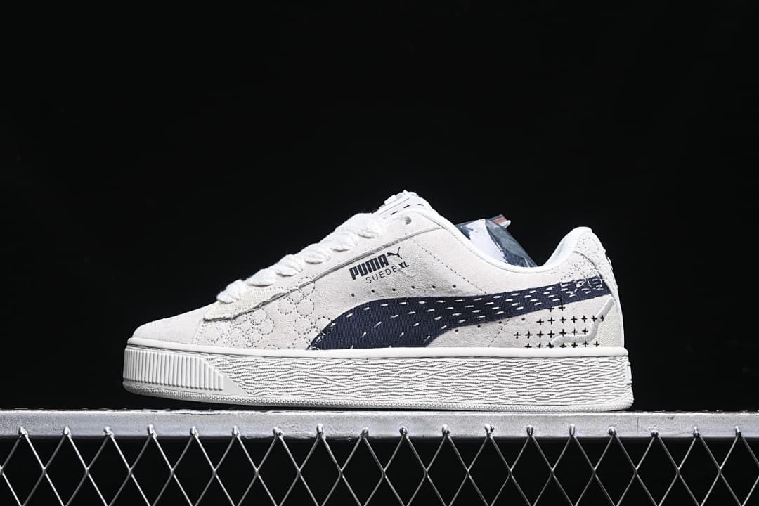 Side profile of the light-colored Puma Suede XL sneaker.