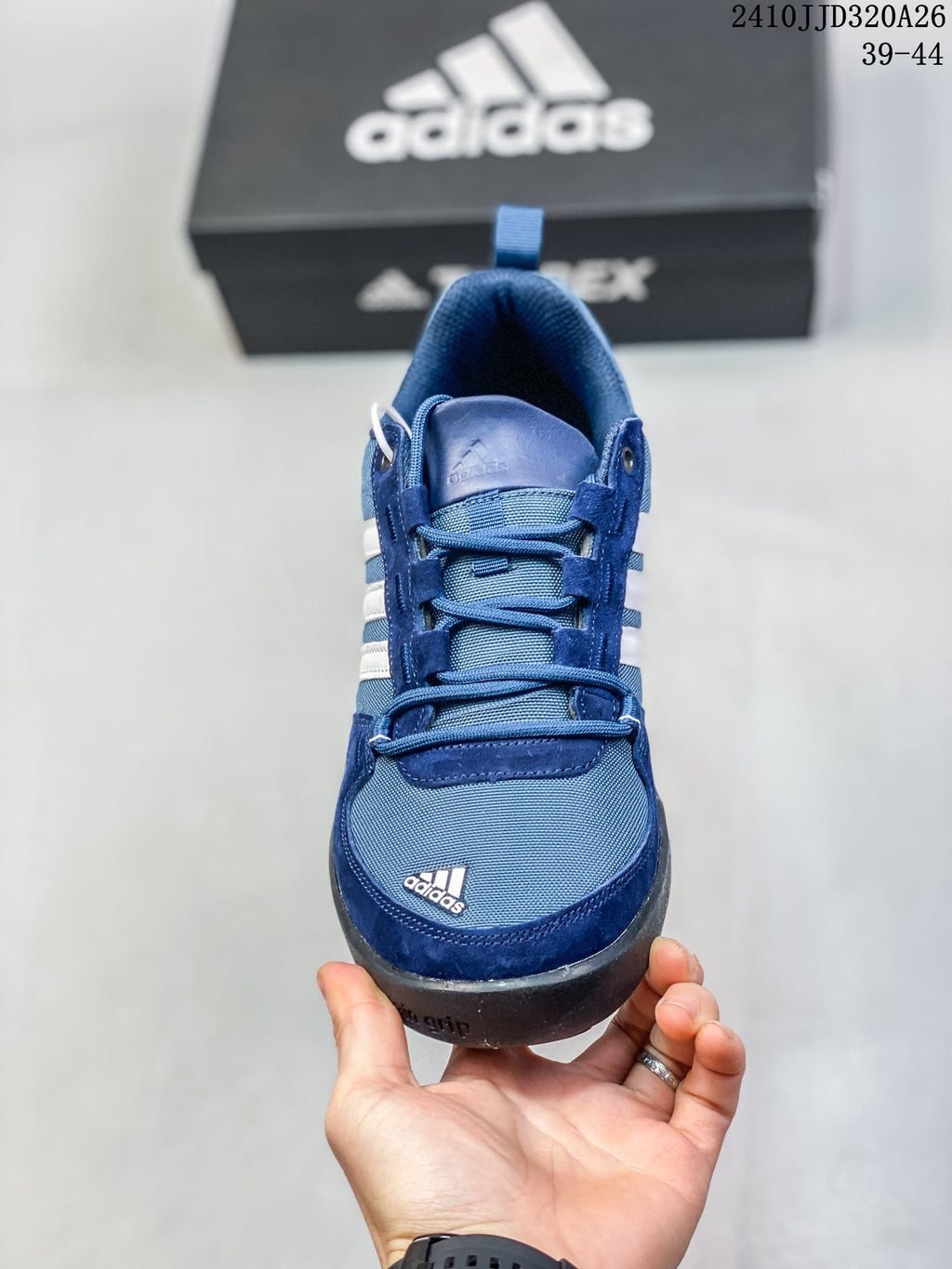 Front view of the blue adidas Daroga Plus Canvas shoe with laces and white stripes.