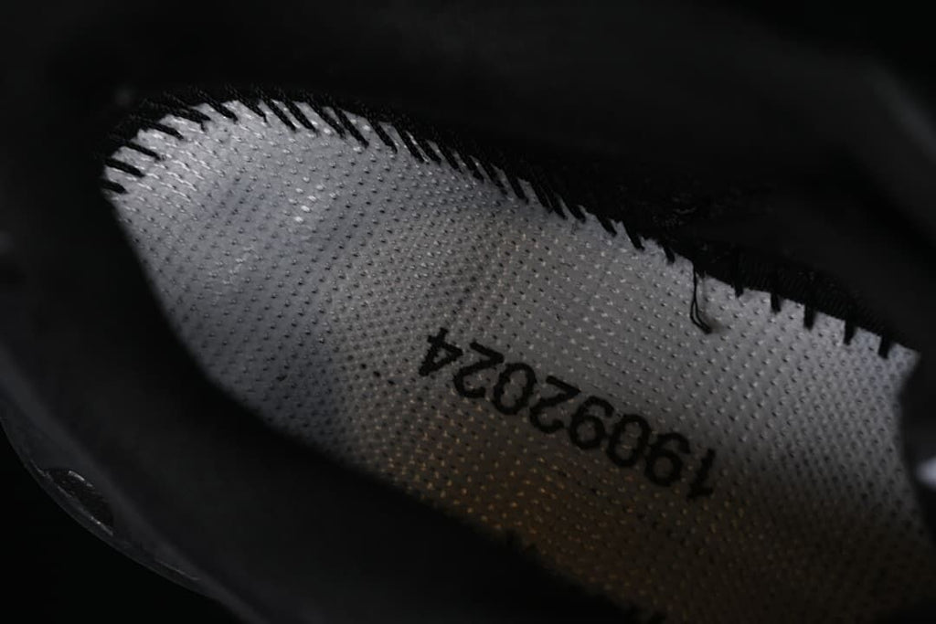 Close-up of the shoe interior showing a printed production code.