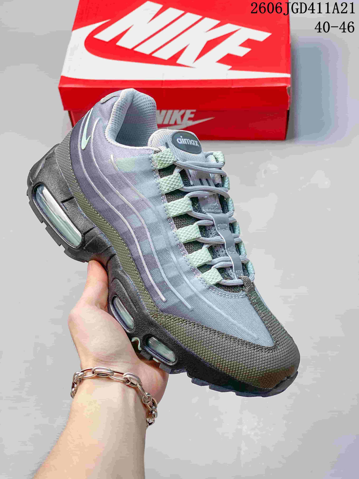 Side view of a gray Air Max 95 sneaker with pale green accents and visible sole air units