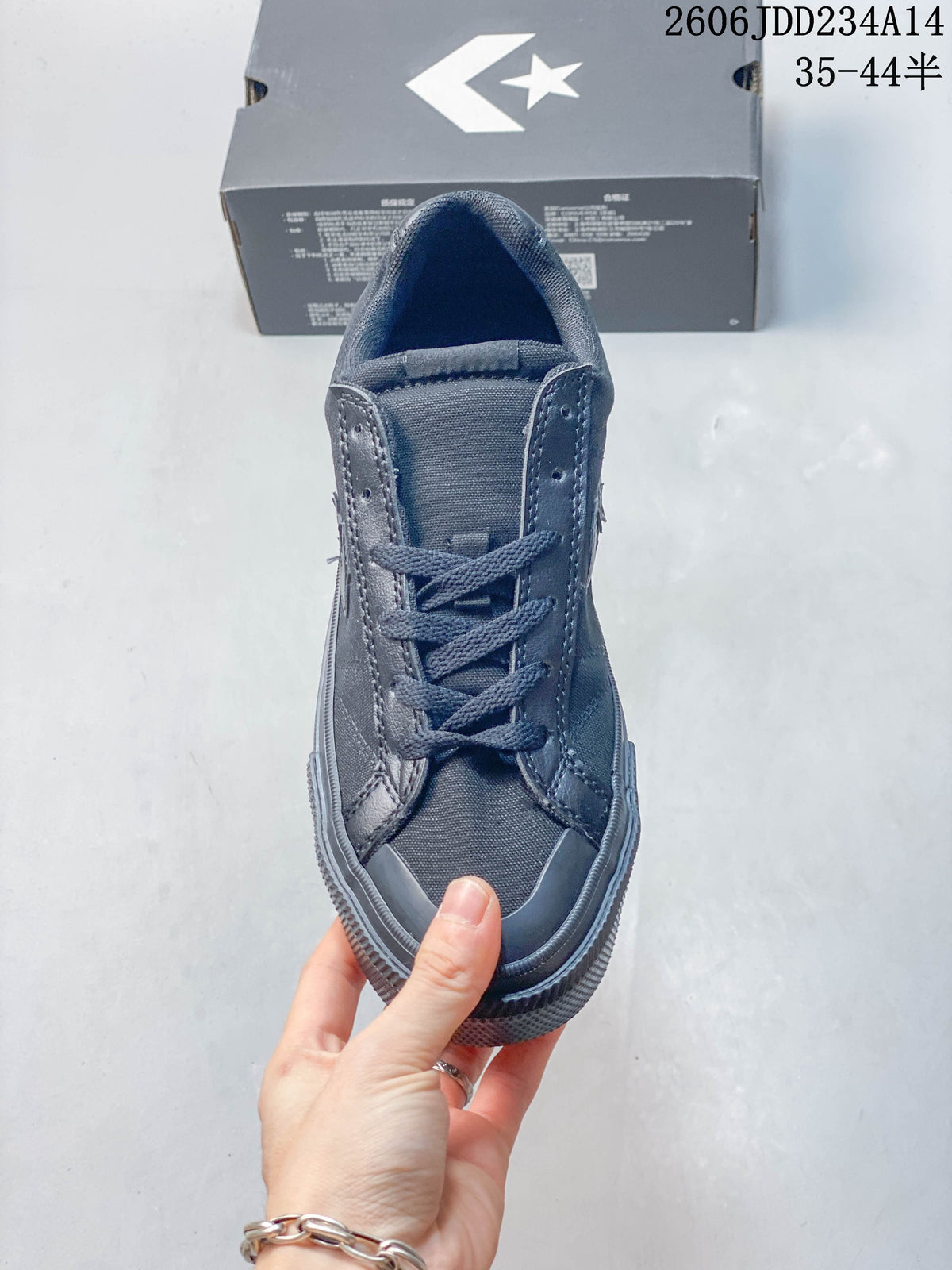 Front view of a charcoal Converse lace-up sneaker