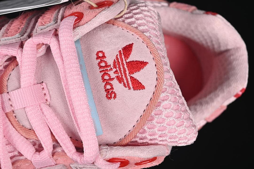Close-up of the tongue with adidas branding and pink laces.