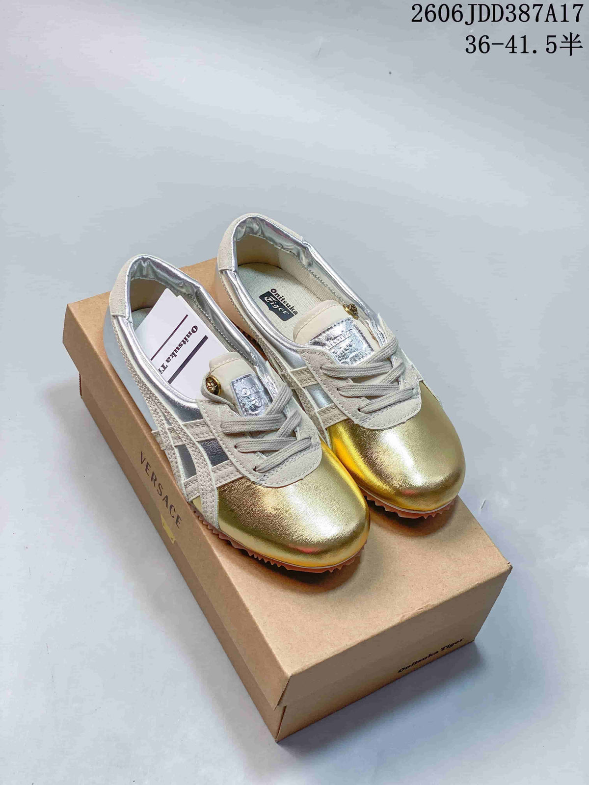 Pair of gold and silver low-top lace-up sneakers with cream accents.