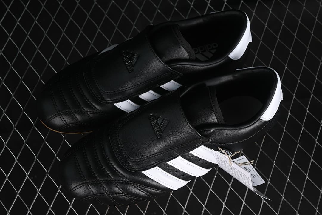 Pair of black and white Adidas Taekwondo sneakers shown from above.