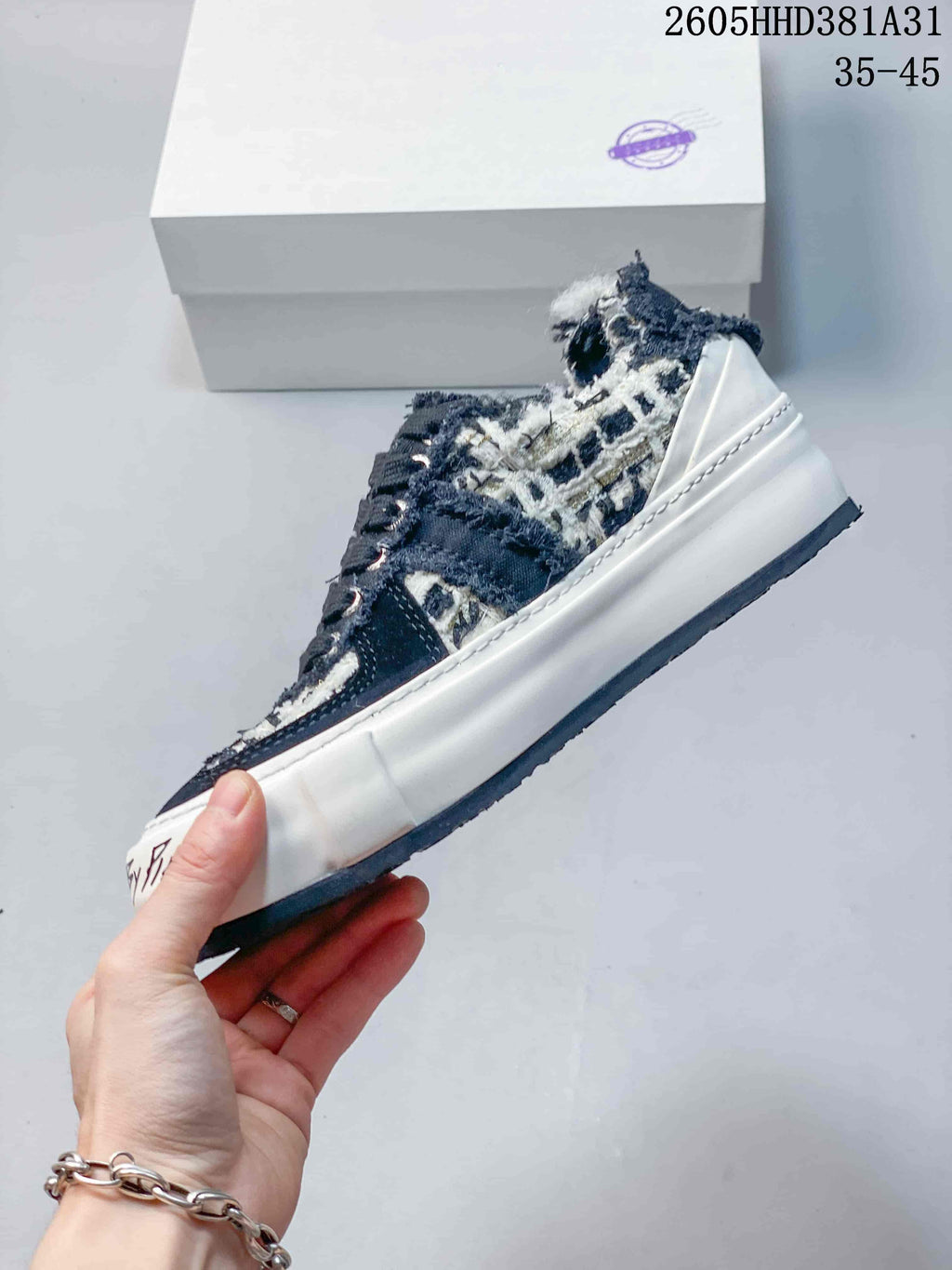 Side profile of a low-top sneaker with a patterned upper and thick off-white sole.