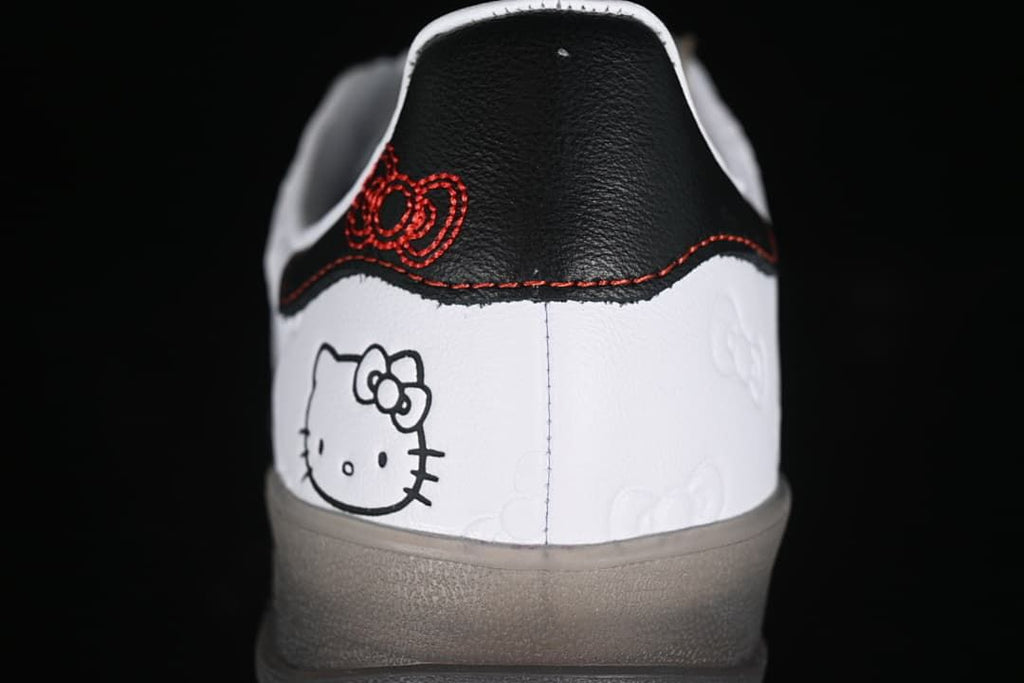 Heel close-up showing Hello Kitty artwork and a black heel tab with red embroidery.