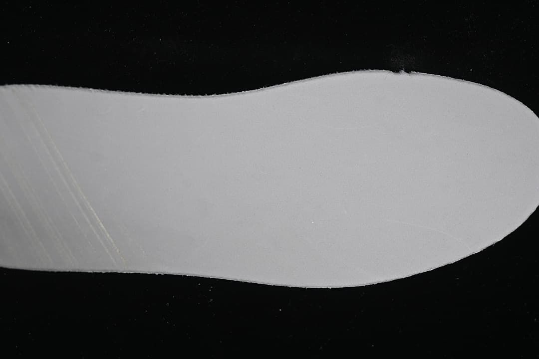 Close-up of a plain light-colored shoe insert.
