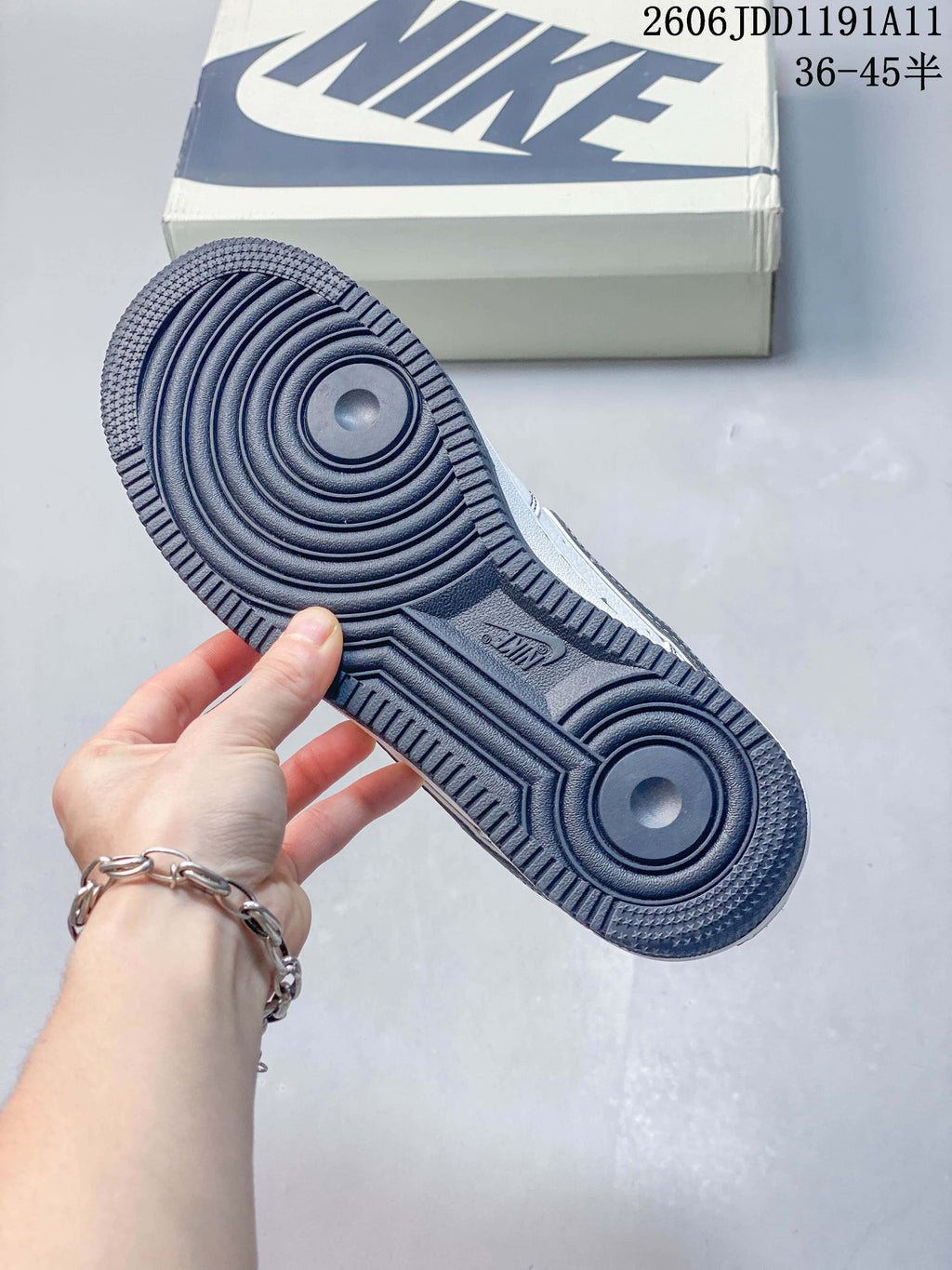 Close-up of the navy outsole on a white low-top sneaker