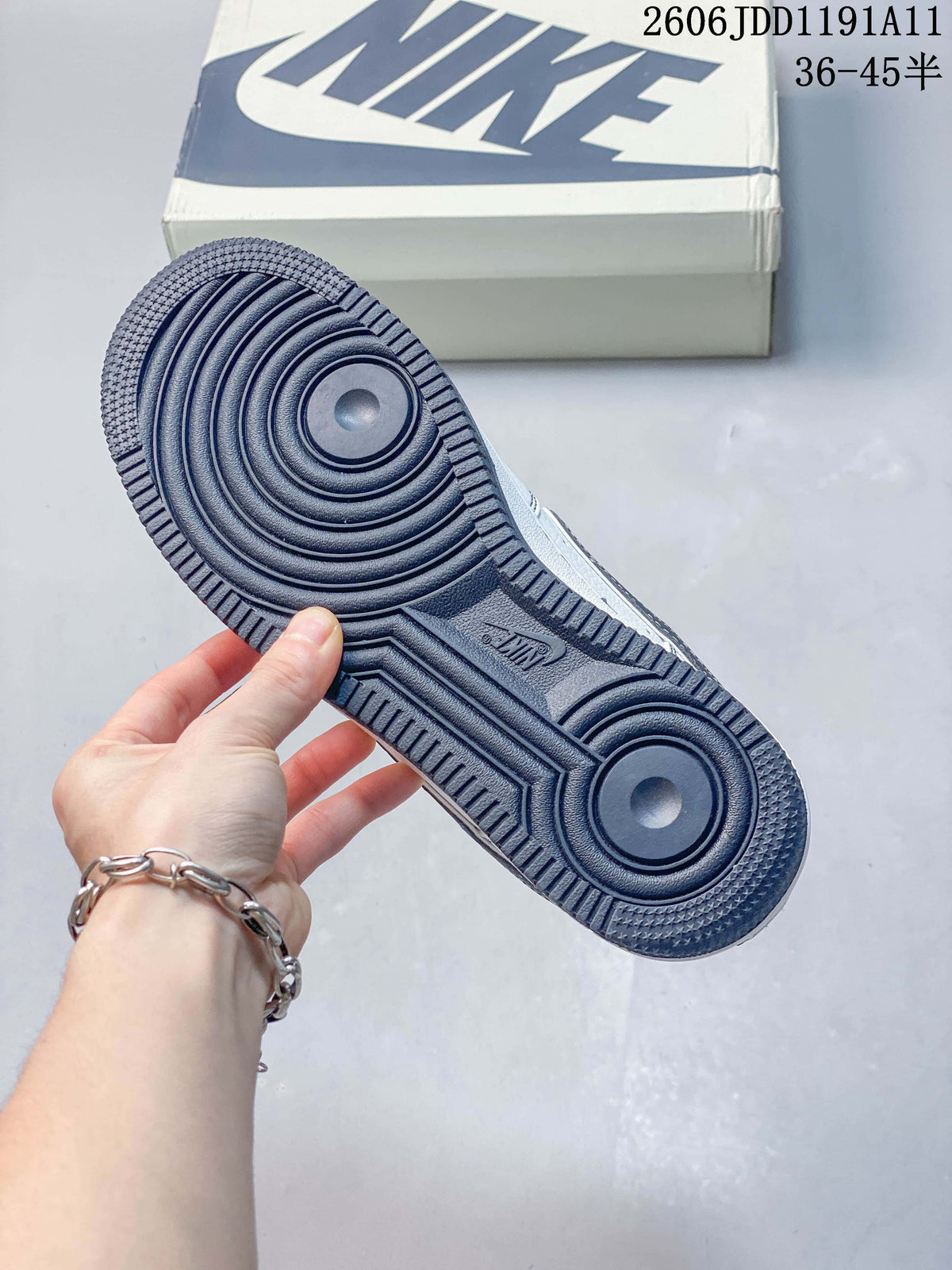 Close-up of the navy outsole on a white low-top sneaker