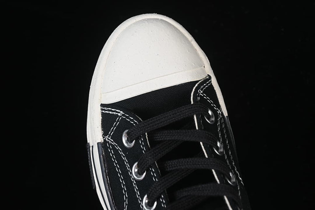 Top view of the black laces and white toe cap