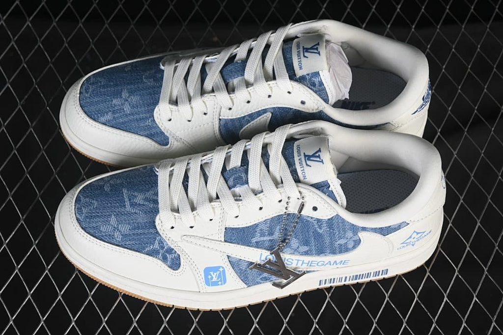 Pair of low-top sneakers showing blue patterned panels, white laces and overlays, and a decorative metal lace accessory.