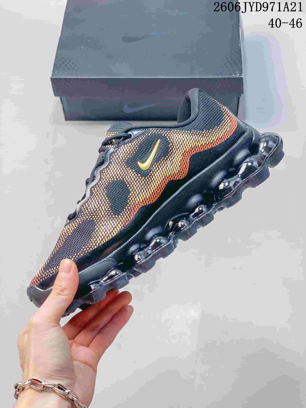 Side profile of the Nike Air Liquid Max shoe with gold accents and a bubble-like outsole