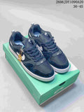 Pair of navy Nike SB Alleyoop low-top shoes with white Swooshes on a green shoe box