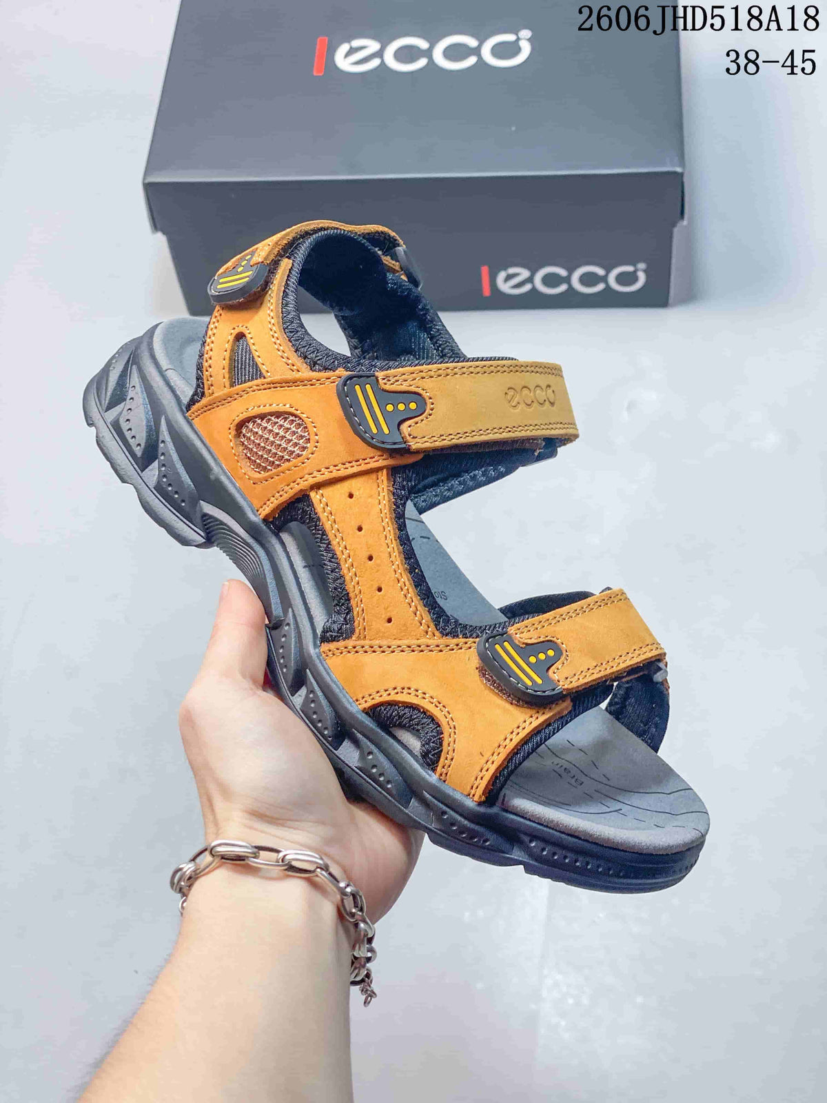 Angled view of an orange and gray sandal with multiple adjustable straps.