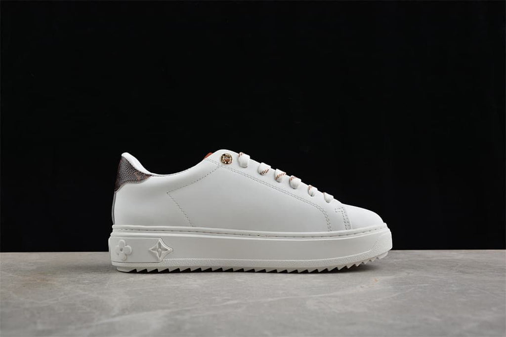 Side view of the white sneaker with raised platform and sawtooth outsole