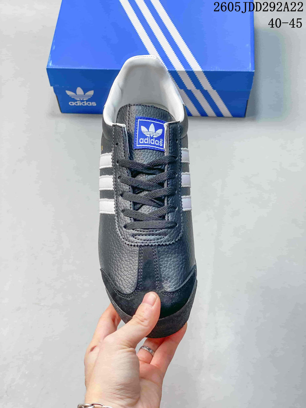 Top view of a charcoal Adidas Samoa sneaker showing its laces and white lining