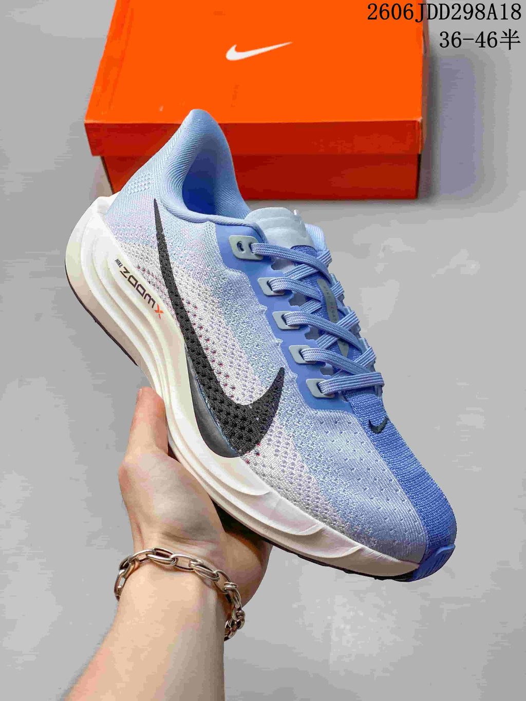 Angled side view of the light blue running shoe with a dark Swoosh and white midsole