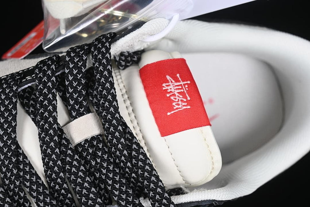 Close-up of the patterned black laces and red tongue label
