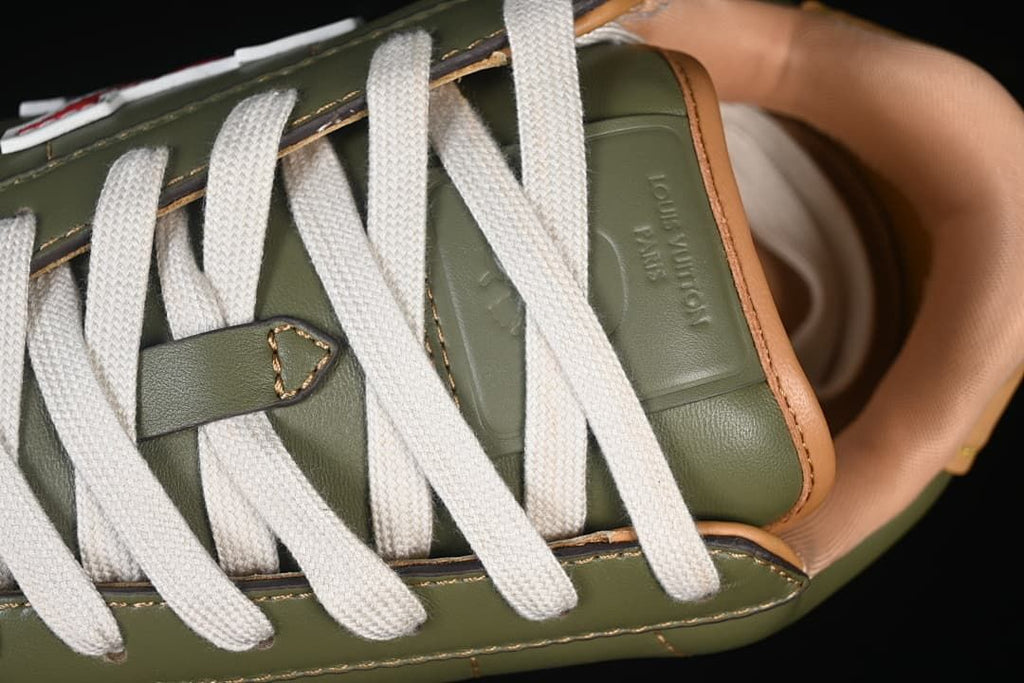 Close-up of cream laces and embossed tongue branding