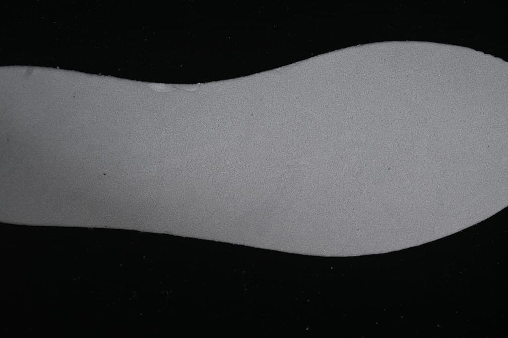 Close-up view of a gray shoe sole component