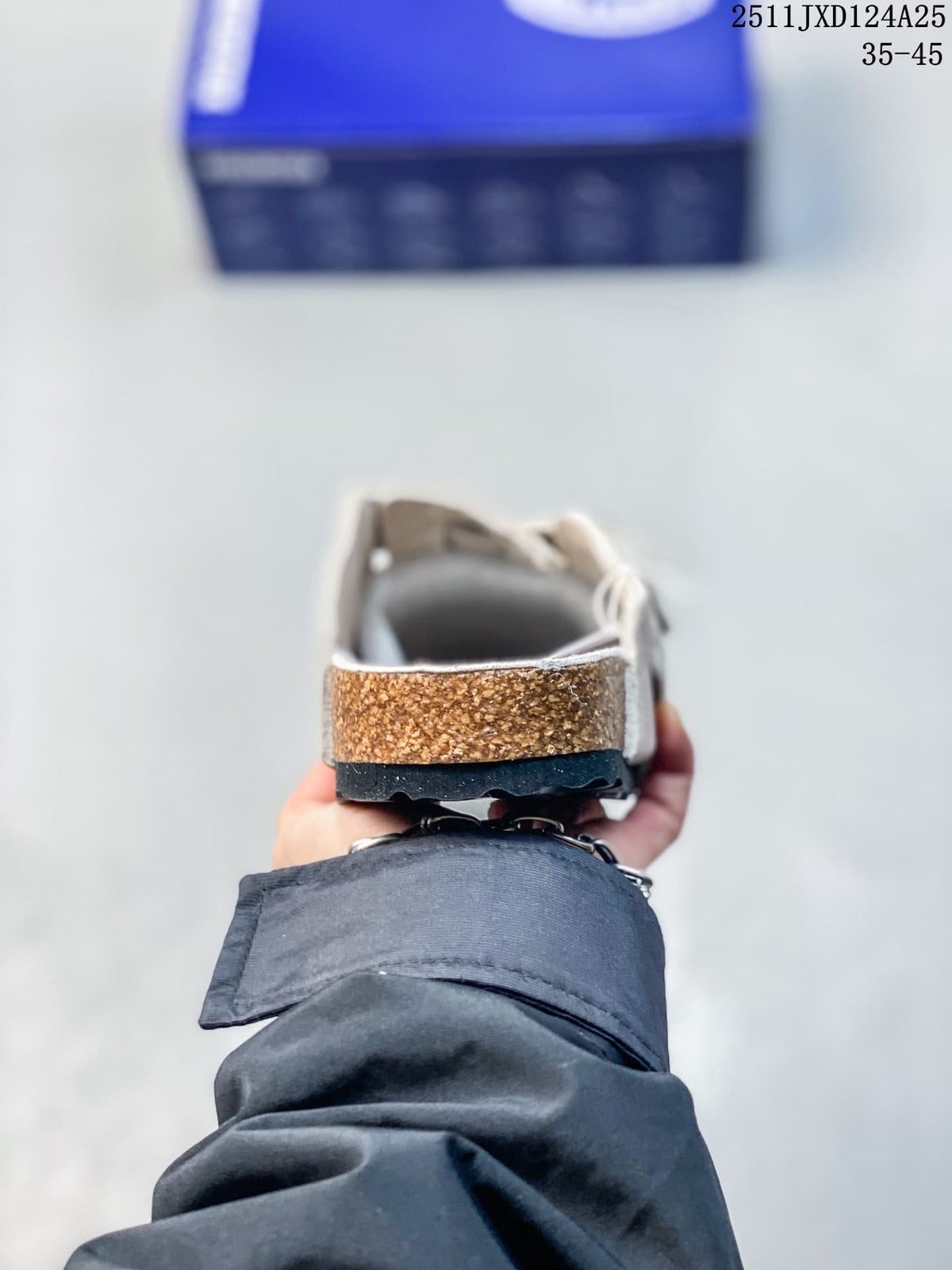 Rear view showing the cork-look midsole and black outsole of a taupe clog