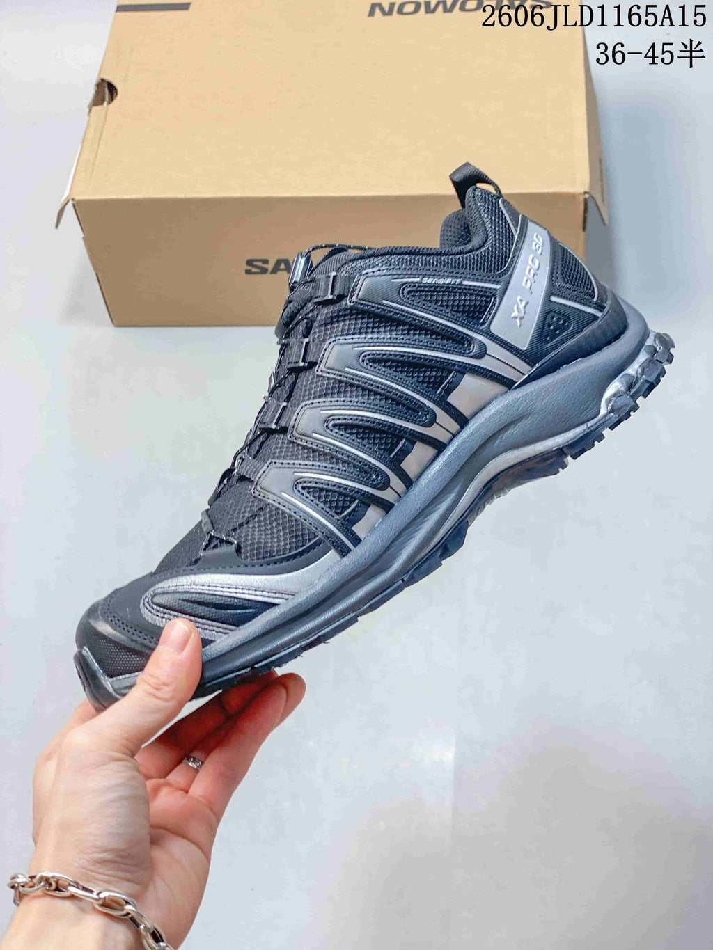 Side view of a charcoal gray Salomon XA Pro 3D shoe with silver-gray overlays and cord lacing; image overlay lists sizes 36–45.5.