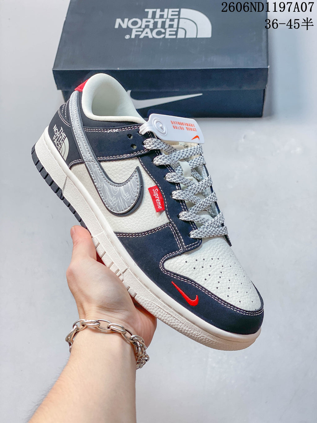 Angled side view of the low-top sneaker with gray patterned swoosh and red accents