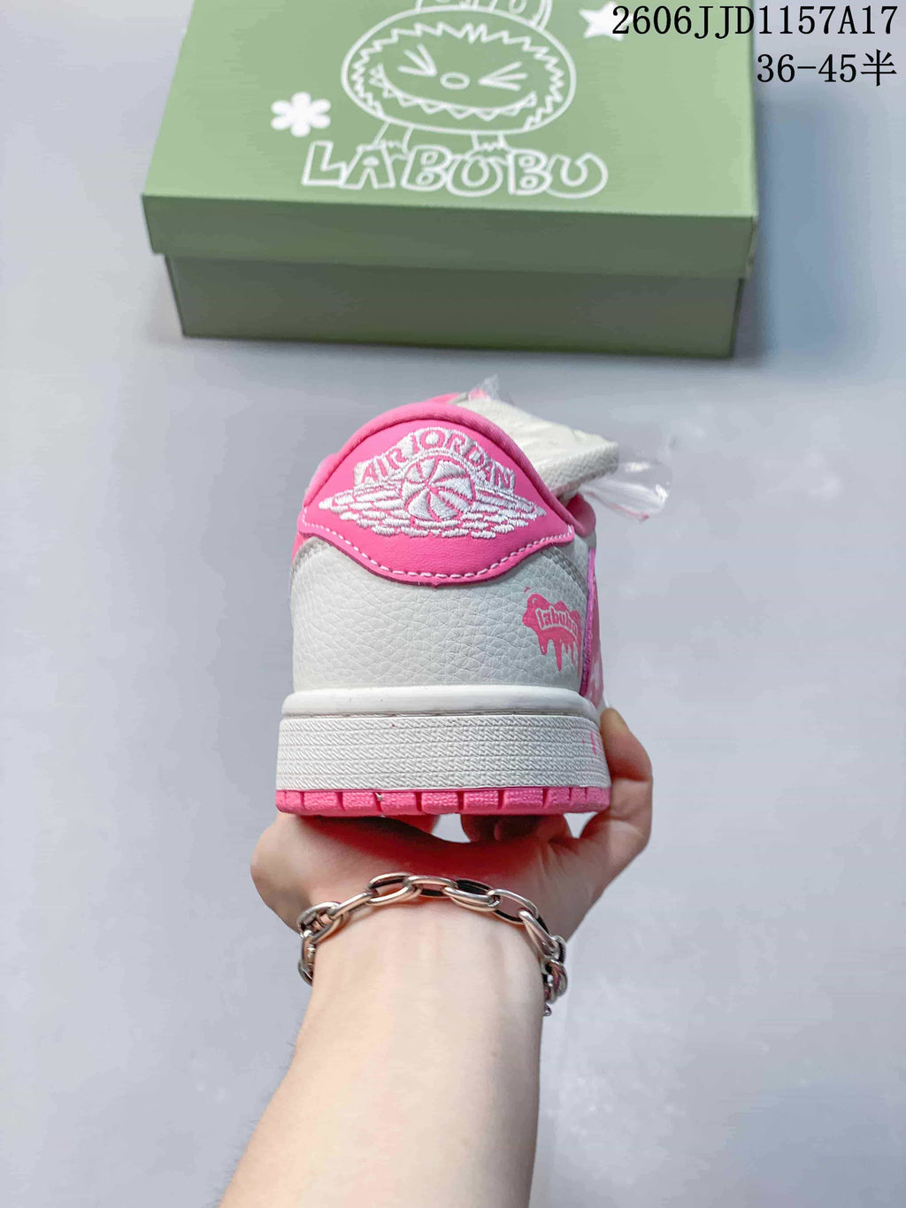 Rear view showing a pink heel panel and white midsole