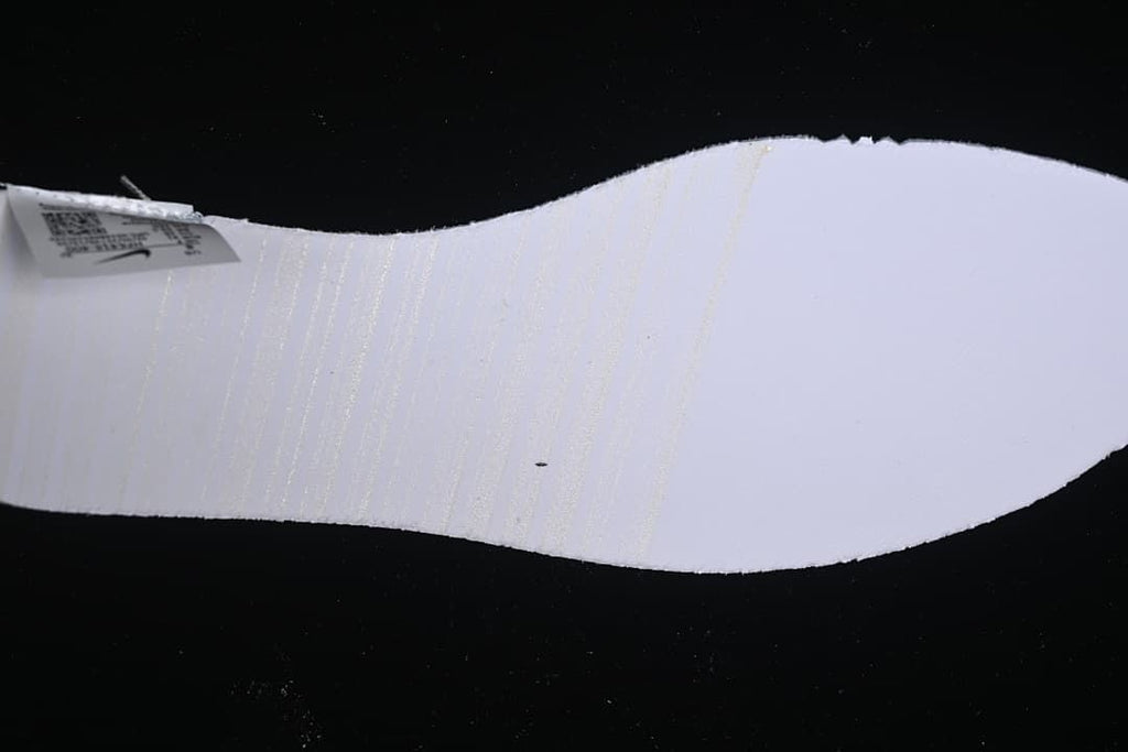Underside view of the shoe's light-colored insole