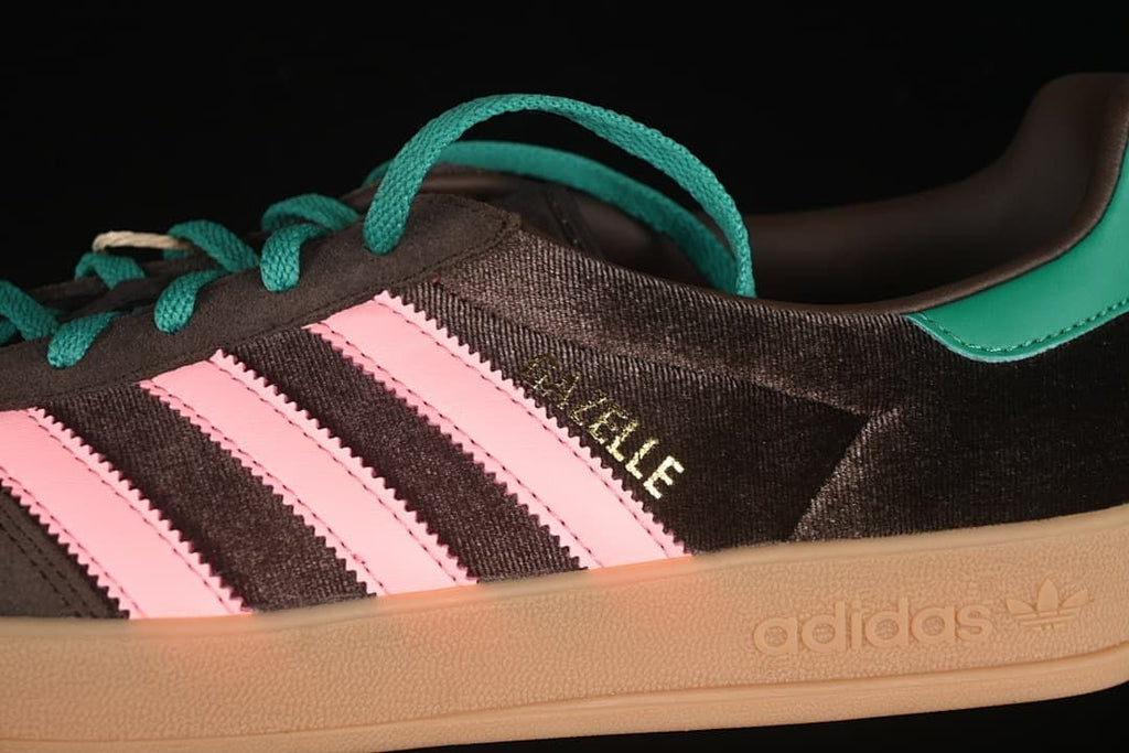 Detail of the Gazelle side marking, pink stripes, teal laces, and embossed adidas midsole branding.
