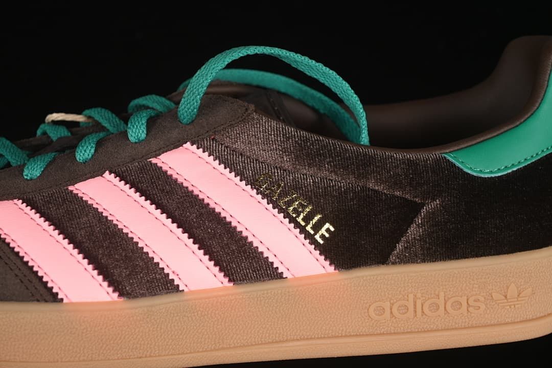 Detail of the Gazelle side marking, pink stripes, teal laces, and embossed adidas midsole branding.