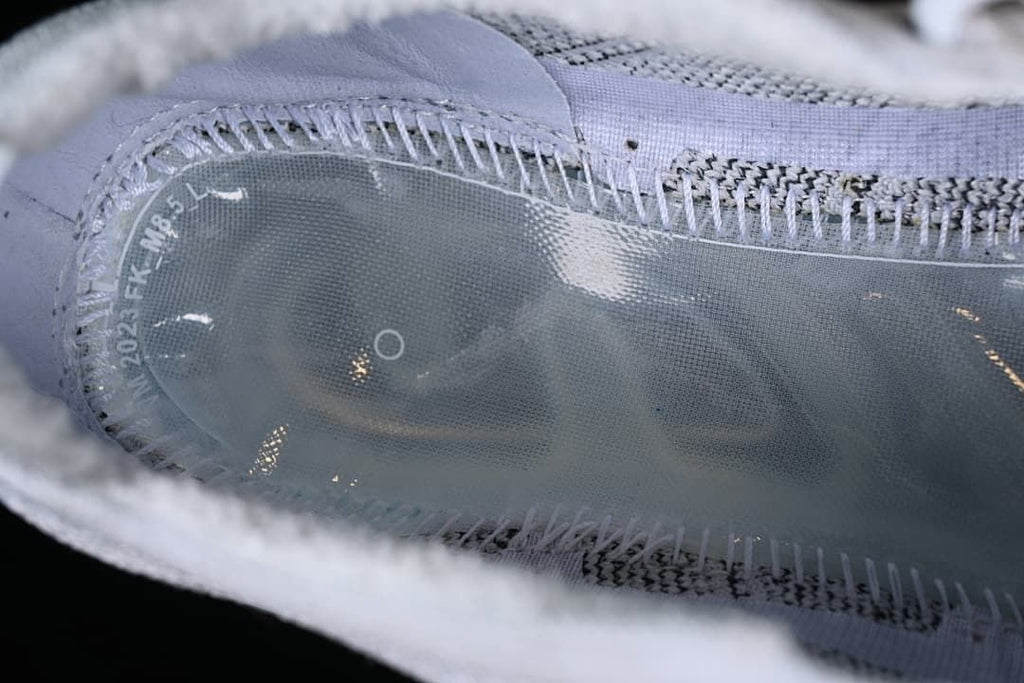 Close-up of stitching and construction along the translucent sole edge.