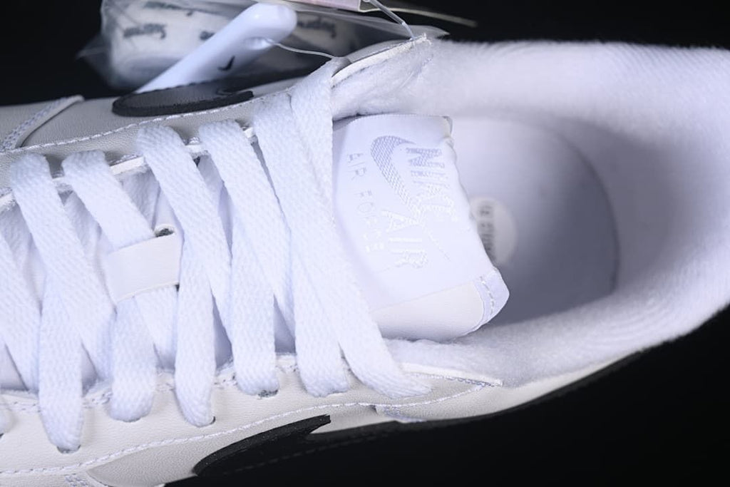 Close-up of white laces, tongue and padded collar