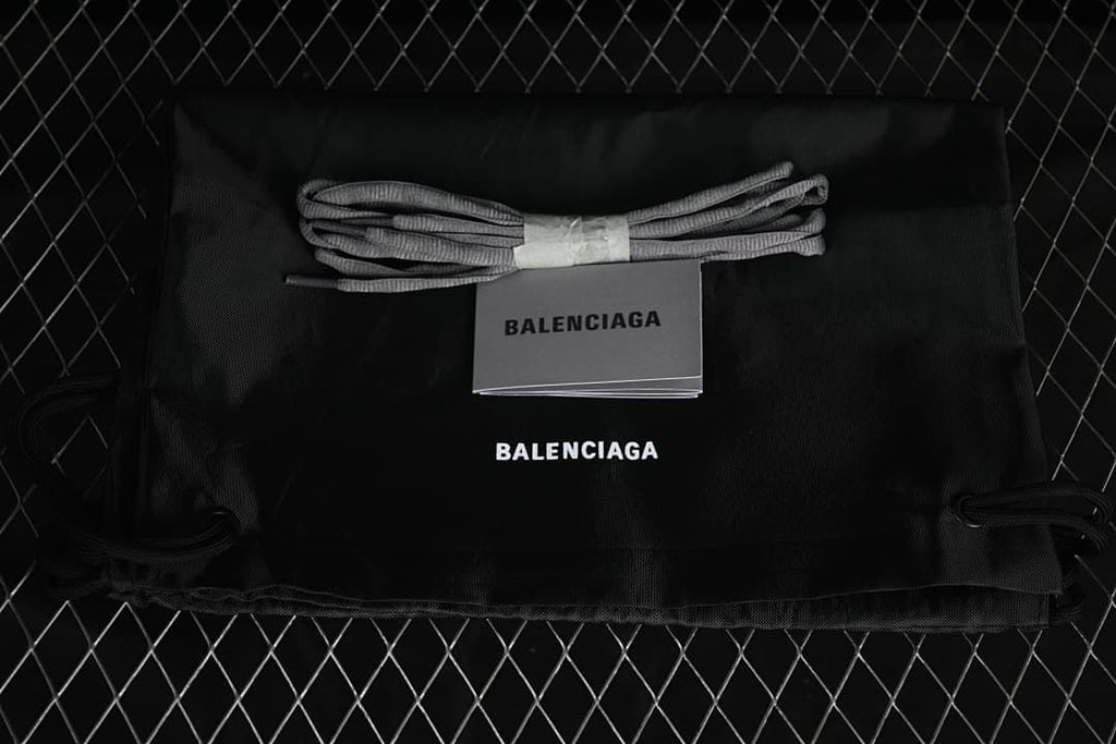 Drawstring bag, spare laces, and booklet shown beside one another.