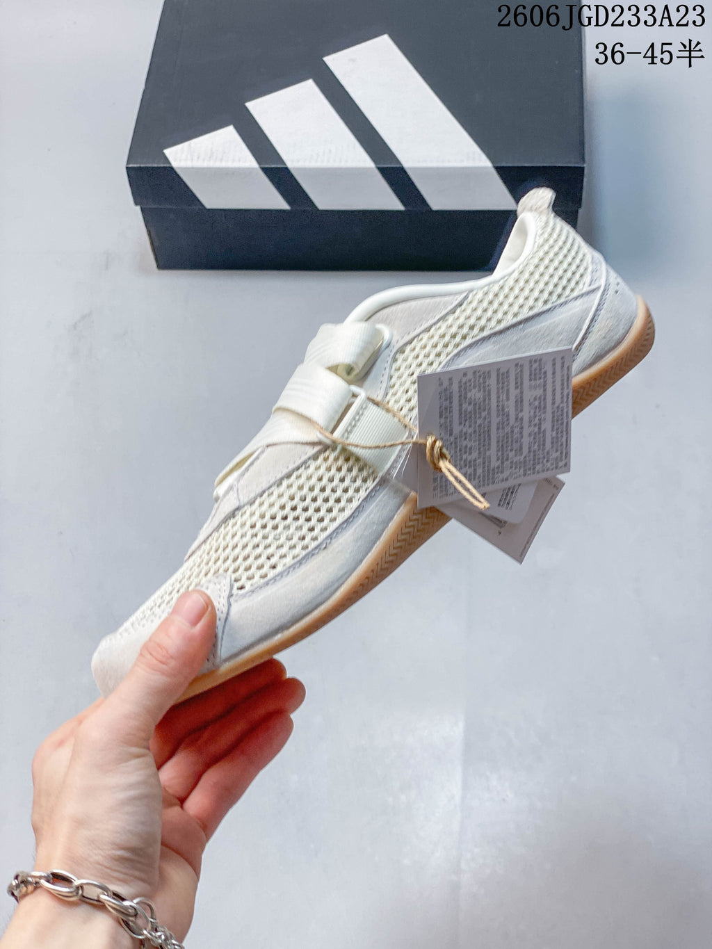 Side view of an off-white adidas Urban Reverie sneaker with mesh-look panels and strap-style closures