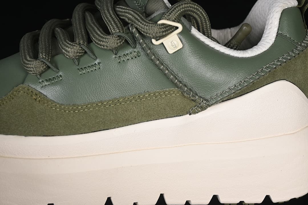 Close-up of the green upper, suede-like overlay, stitching and thick sole