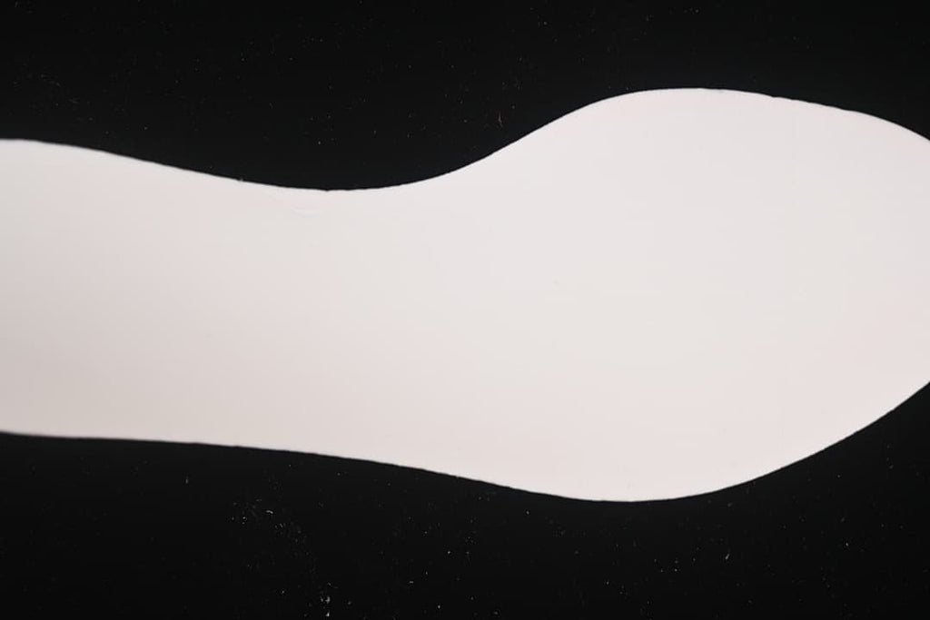 White shoe insole shown separately against a dark background