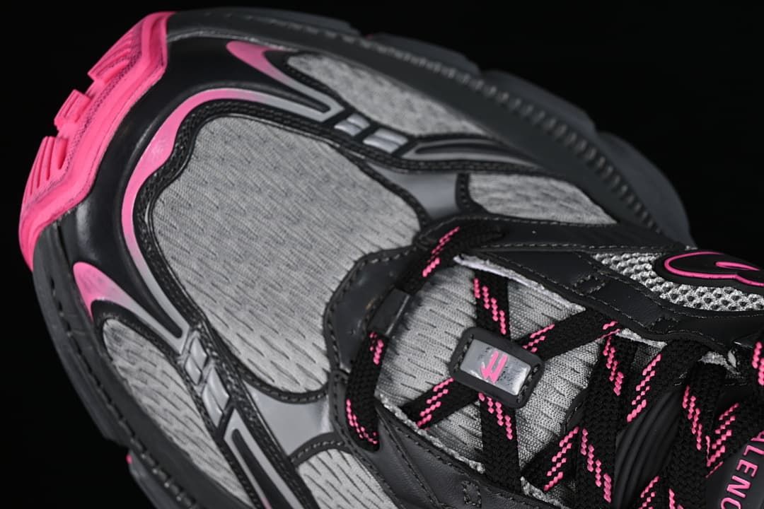 Close-up of the grey upper panels, black overlays and pink accents