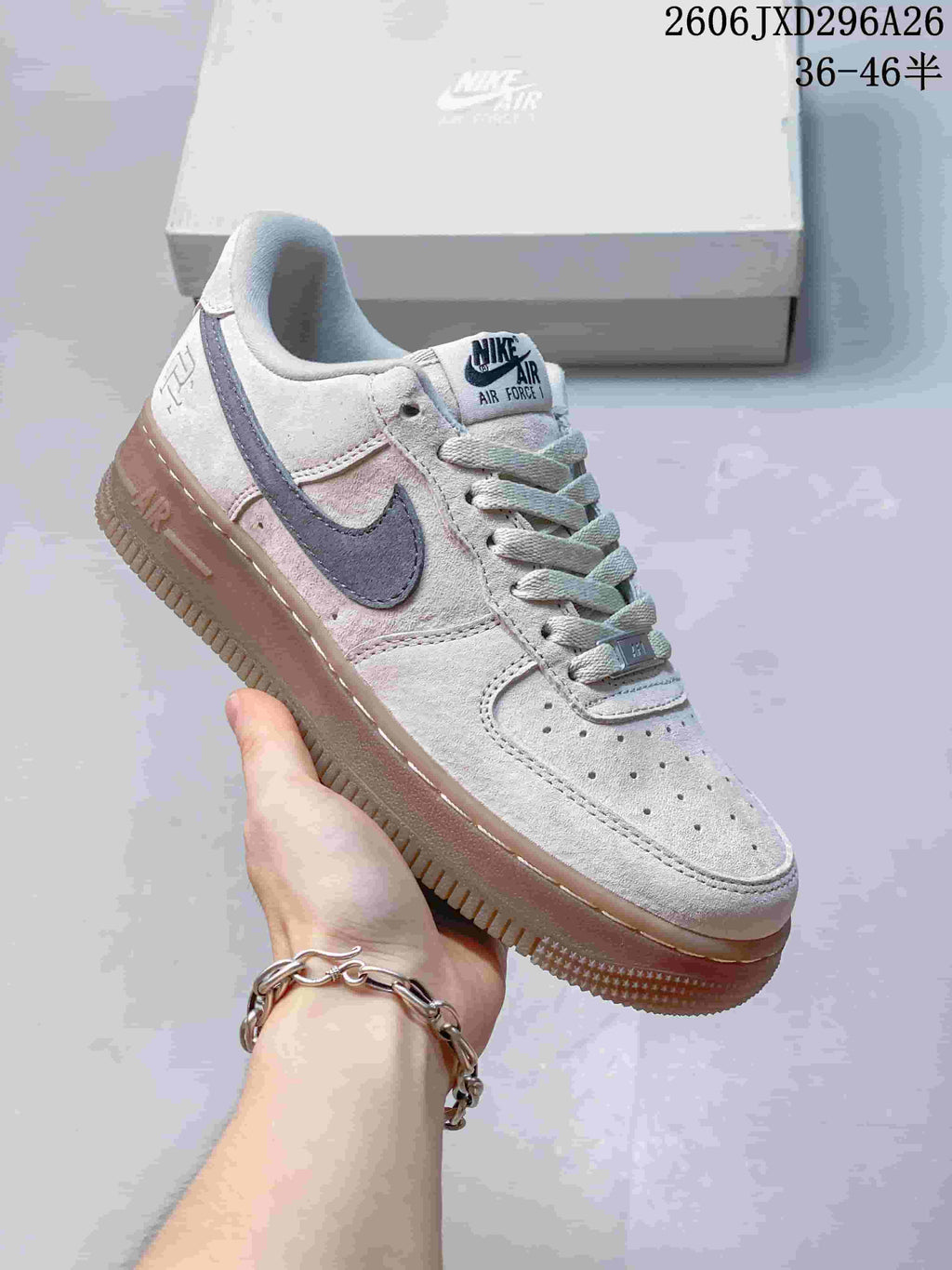Close-up of a light gray Nike Air Force 1 sneaker with a dark Swoosh