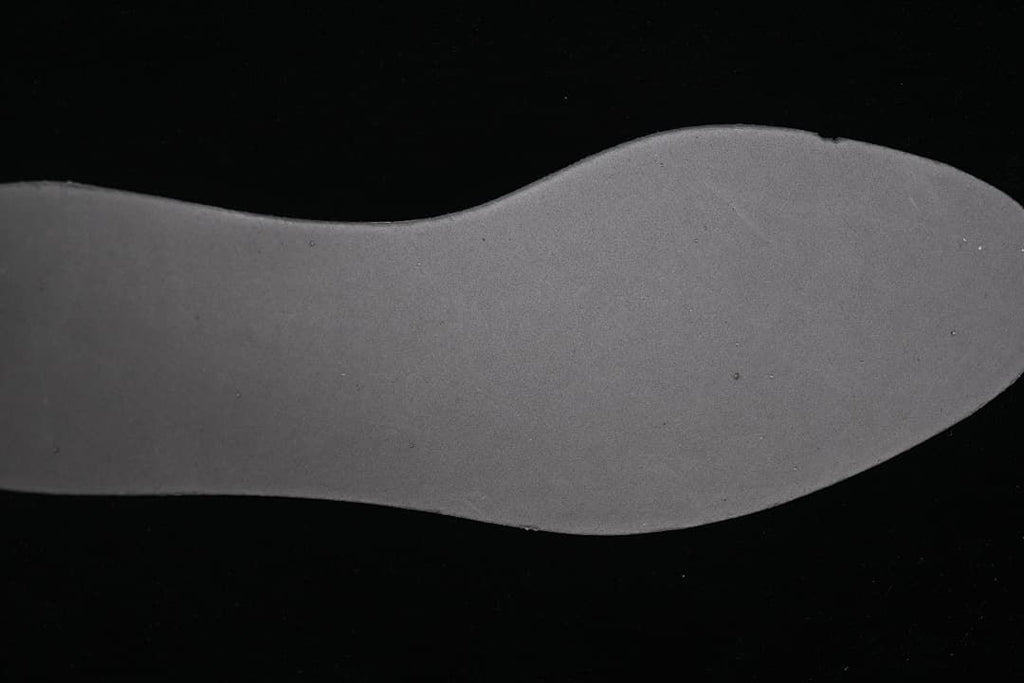 Underside view of the dark shoe insole.
