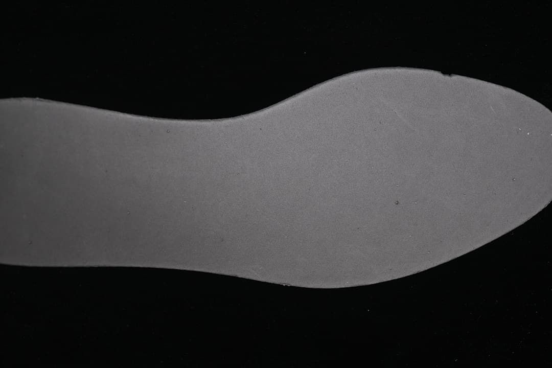 Underside view of the dark shoe insole.