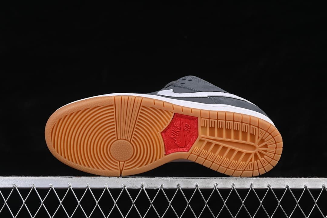 Underside view of the gum-colored outsole with circular tread and a red center detail.