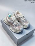 Pair of cream, gray, and muted pink Balenciaga 3XL-style chunky sneakers shown from the front