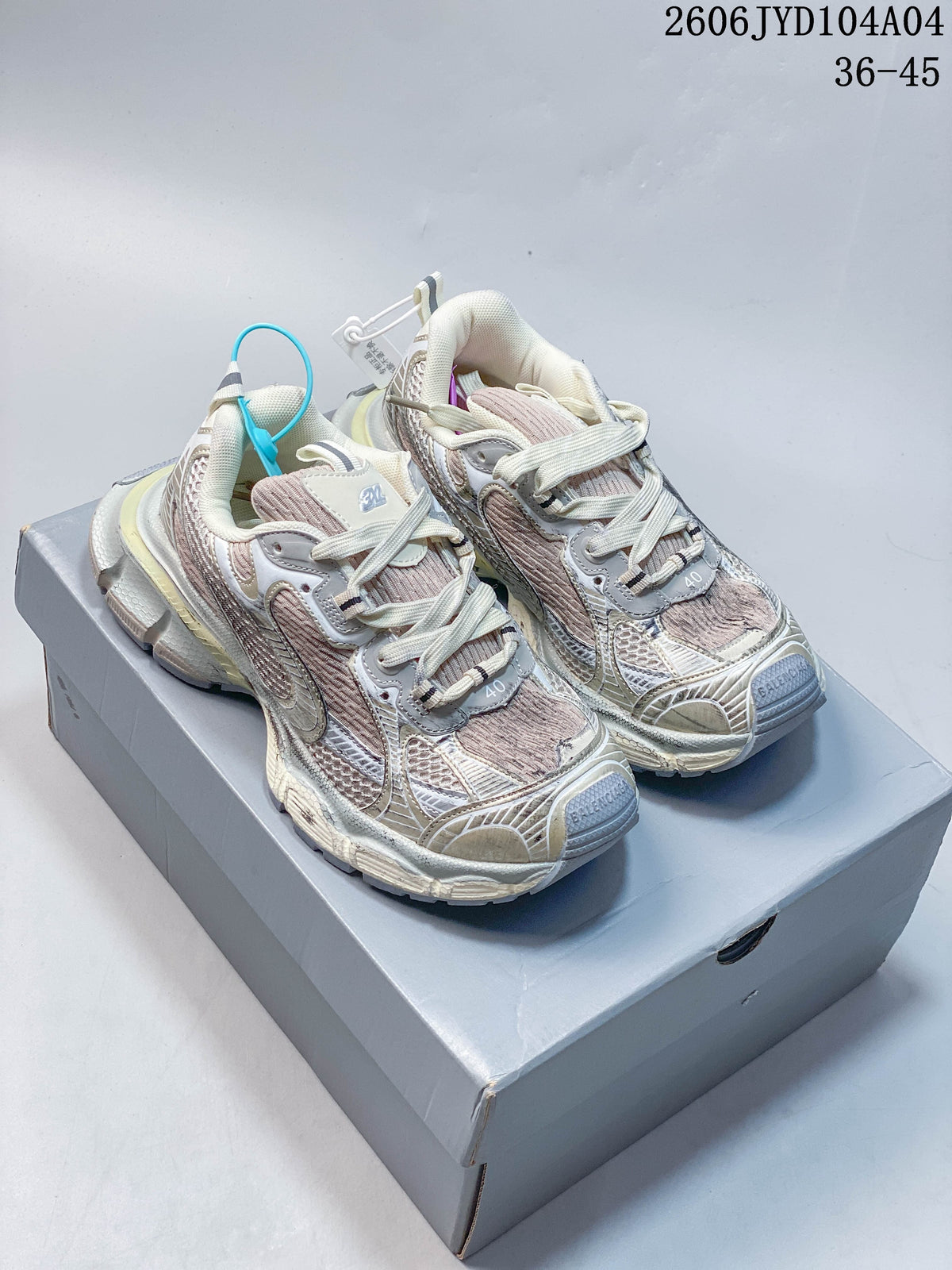Pair of cream, gray, and muted pink Balenciaga 3XL-style chunky sneakers shown from the front